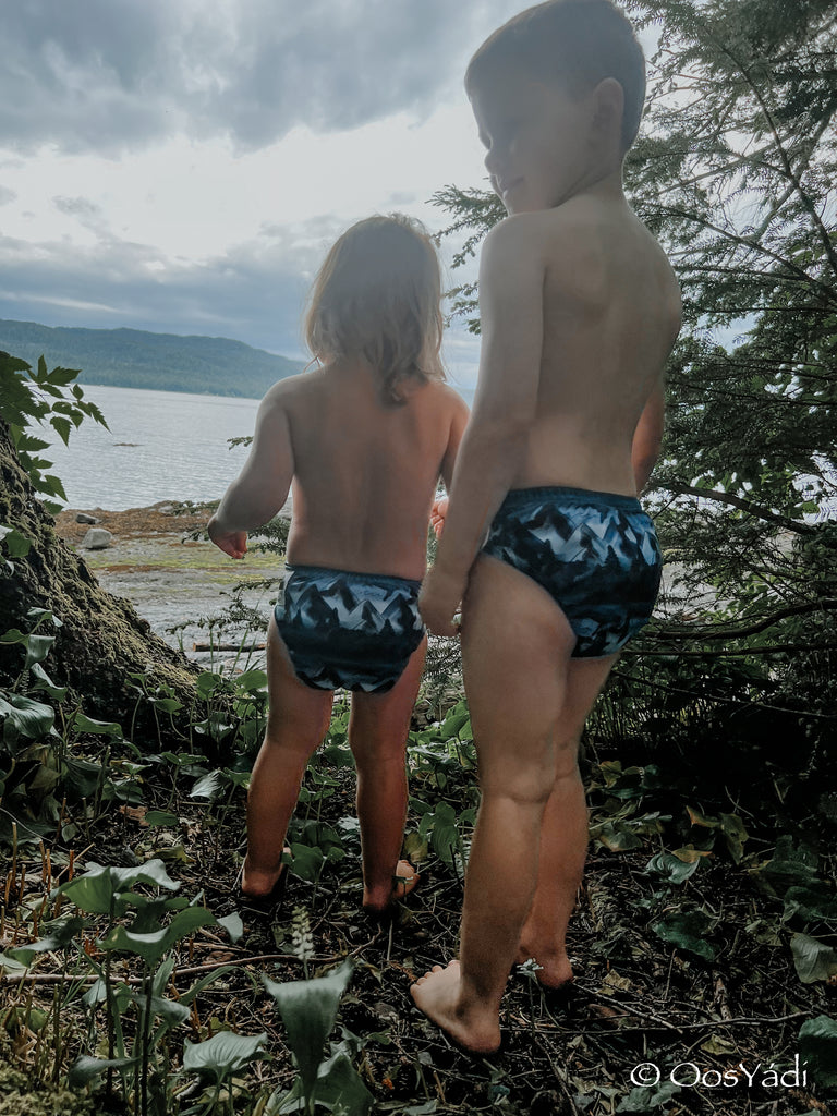 Children wearing cloth diapers in the forest